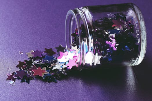 pexels-photo-3147957-3147957-1 Close-up of colorful star-shaped confetti spilling from glass jar on purple surface. Ideal for creative and festive themes.